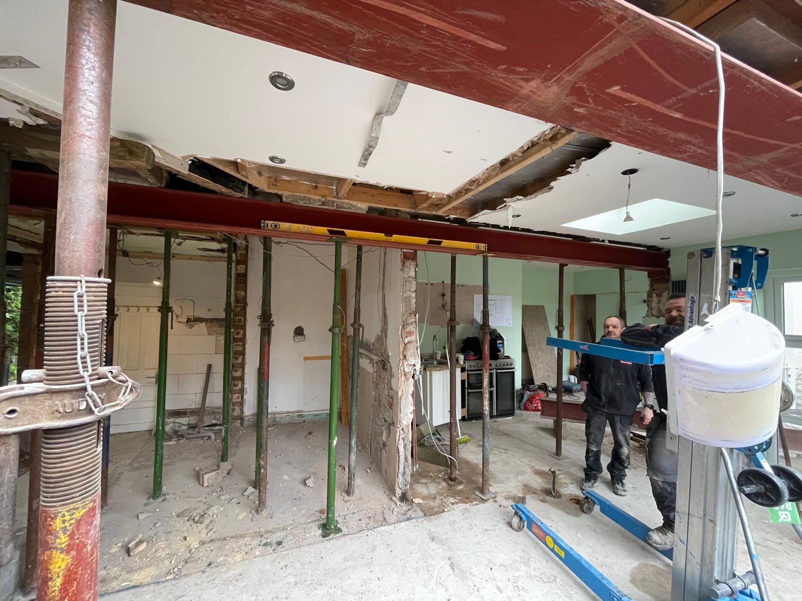A steel beam going in on supports with the room opened up below